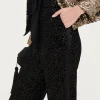 Pantaloni in velluto e paillettes